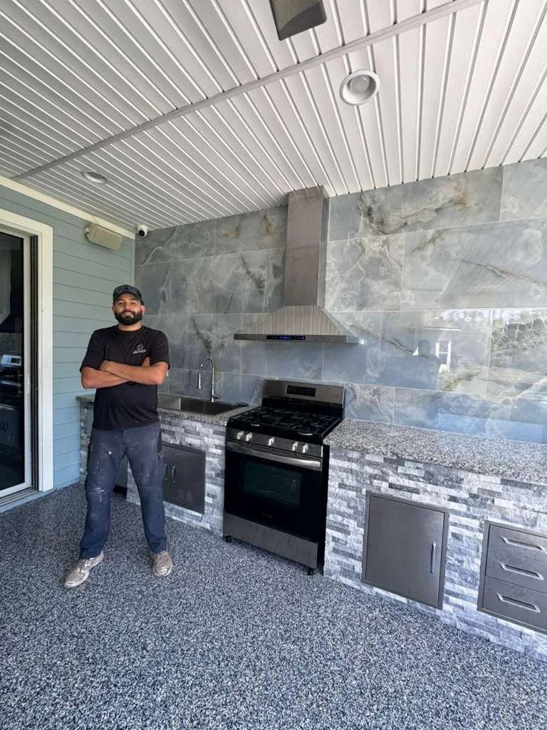Gabe standing beside a completed GS One outdoor kitchen